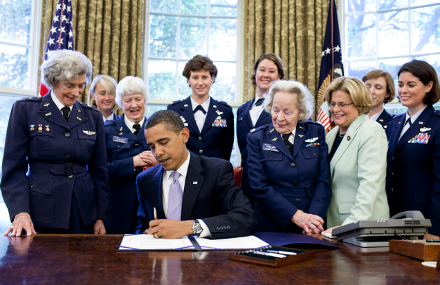 Surrounded by former WASP pilots and current and retired USAF pilots, President Barack Obama signs S.614 in the Oval Office July 1, 2009 at the White House. The bill awards the Congressional Gold Medal to Women Airforce Service Pilots. (Office of the President)